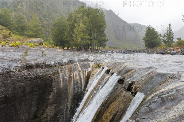 Mountain stream flowing into a crevice