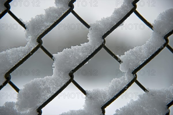 Snow on a chain link fence