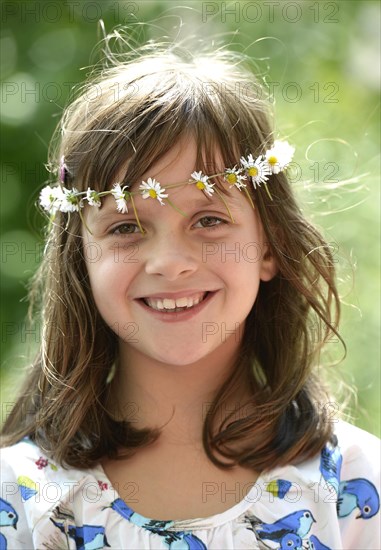 Smiling girl wearing a floral garland