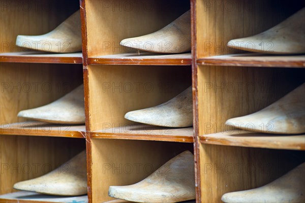 Shelf with antique lasts for manufacturing shoes