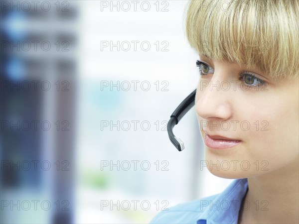 Businesswoman wearing a headset in an office