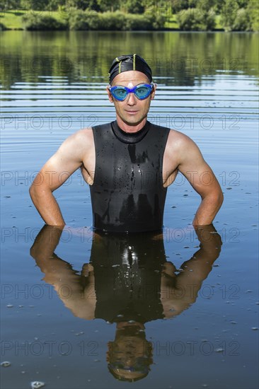 Triathlete standing in Aichstruter Reservoir