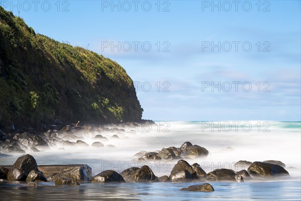 Surf washing over rocks on the beach