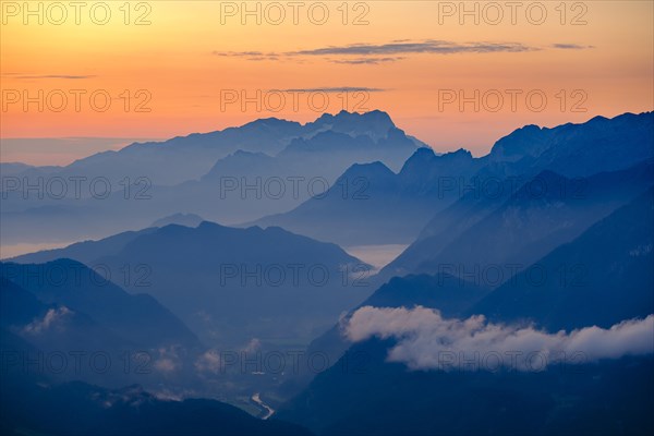 Blue mountain silhouettes at sunrise