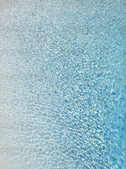 Slightly ruffled turquoise-coloured surface of water in a swimming pool