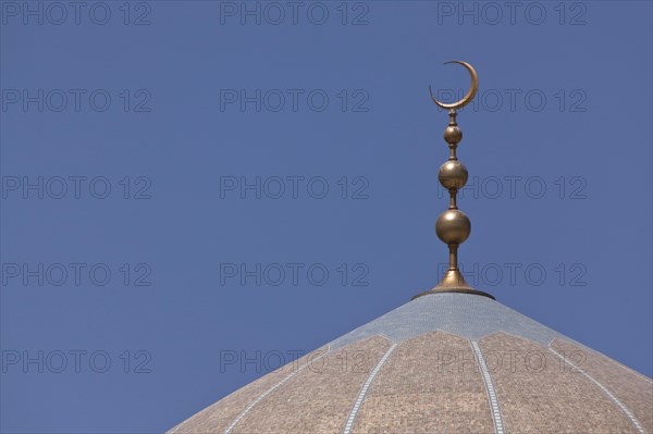 Golden crescent moon on top of a mosque