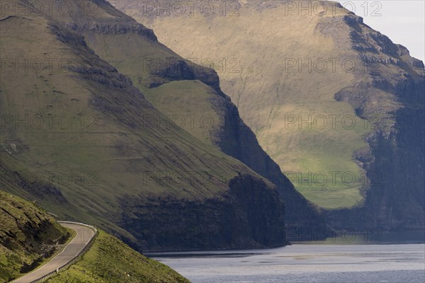 Road and mountains towering from the sea