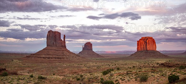 Red glowing rock formation at sunset