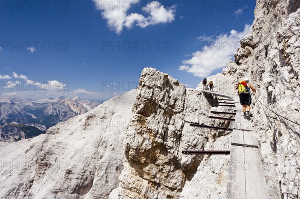 Climber climbing along the Via Ferrata Ivano Dibona climbing route on Monte Cristallo to the summit of Cristallino