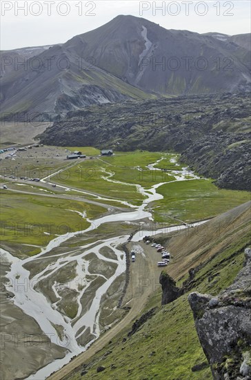 View over the Laugahraun lava field with cabins and a camping site