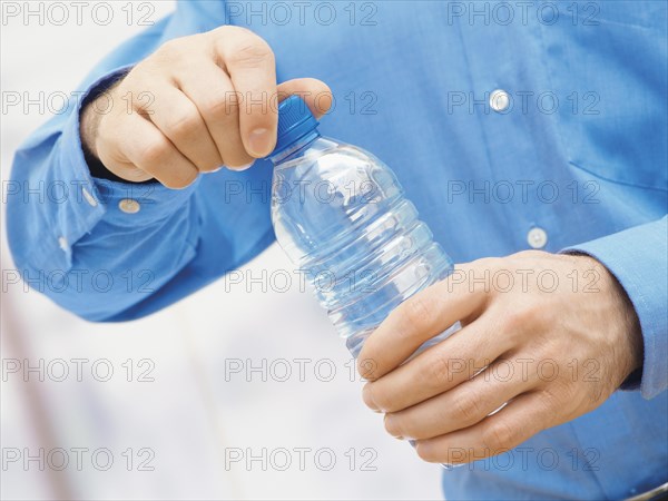 Man opening a water bottle