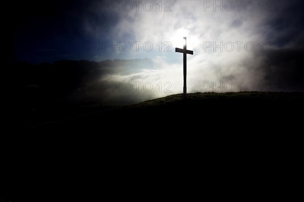 Summit cross of Gerenberg Mountain with high fog in front of the Alpstein Mountains