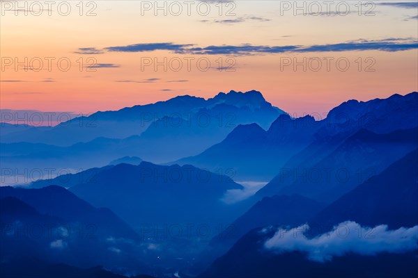 Blue mountain silhouettes at sunrise