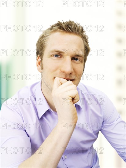 Businessman holding his hand on his chin
