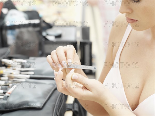 Woman filing her nails