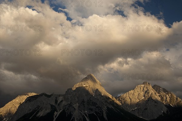 Last sunlight shining on the peaks of the Mieming Range with the mountains Ehrwalder Sonnenspitze and Gruenstein