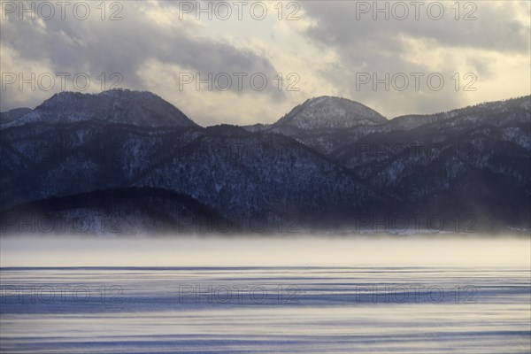 Fog over the frozen Lake Kussharo