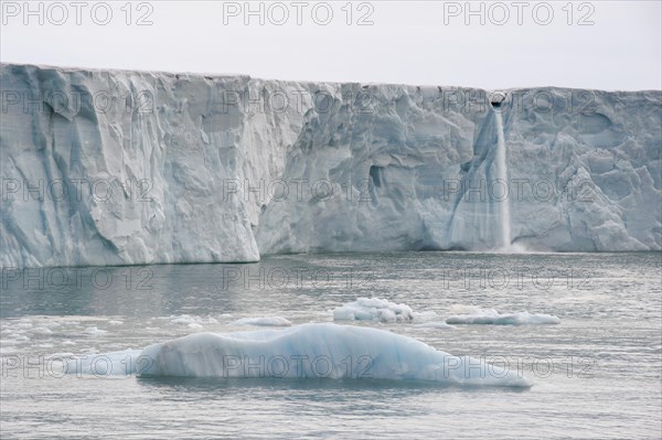 Waterfall of meltwater at the glacier front of Brasvellbreen