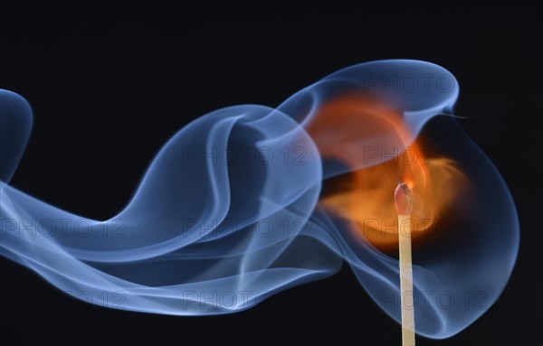 Lit matchstick with a flame and smoke