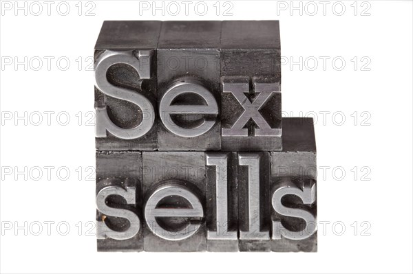 Old lead letters forming the phrase 'Sex sells'
