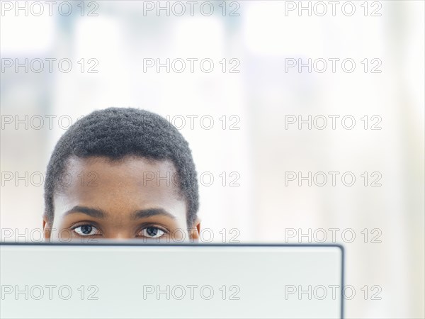 Businessman behind a laptop in an office