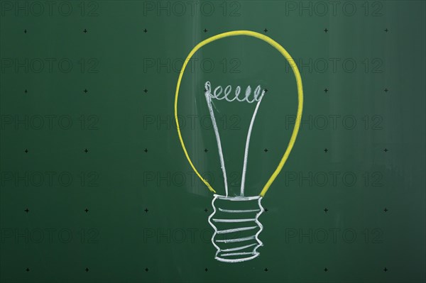 Light bulb drawn with chalk on a blackboard