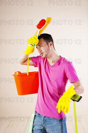 Man looking tired and stressed from cleaning