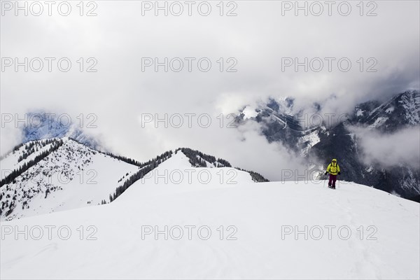 Snowshoe hiker on the summit ridge of Schoenalmjoch in the Karwendel Mountains