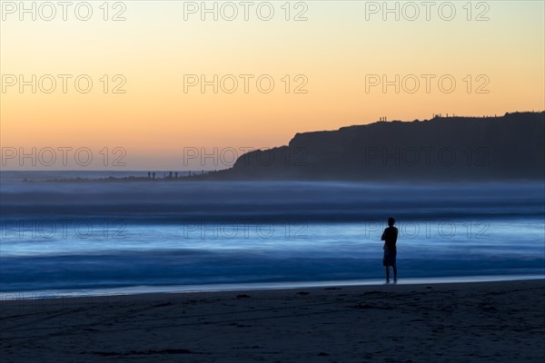 Man on the beach with surf