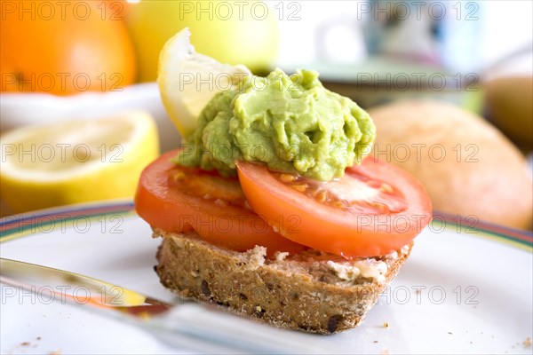 Organic wholemeal bun with a tomato and guacamole
