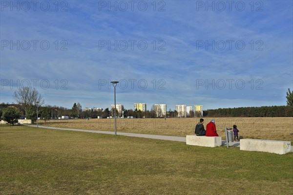 Mother with children sitting on a concrete bench