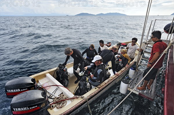 Scuba divers boarding the diving dinghy