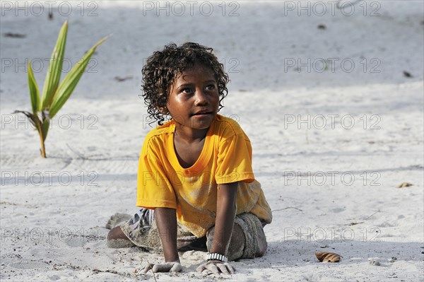 Local girl playing in the sand