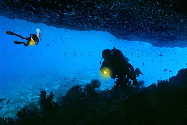 Scuba divers in an underwater cave