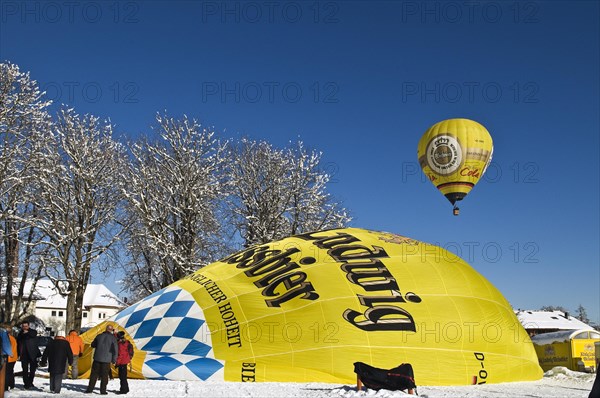 Balloons in the air or balloon envelope being inflated on the ground