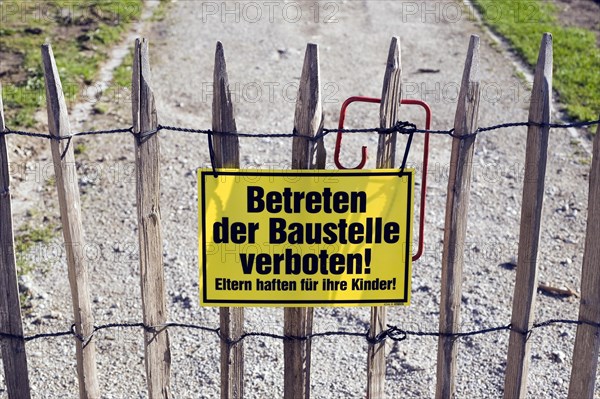 Sign on a picket fence 'Betreten der Baustelle verboten!'