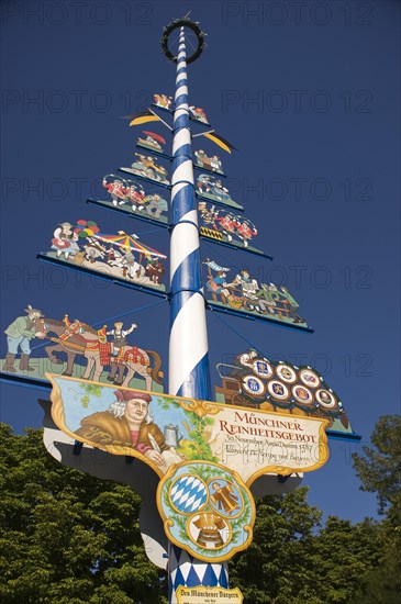 May pole on Viktualienmarkt square with the explanation of the Munich Beer Purity Law of 1487