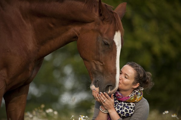 Woman kissing a Hanoverian horse