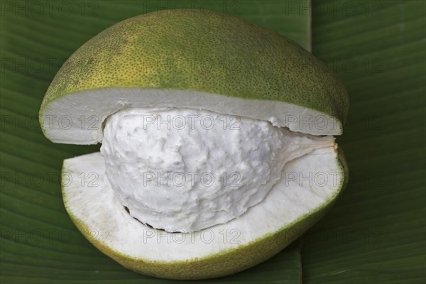 Cut Pomelo fruit on a banana leaf