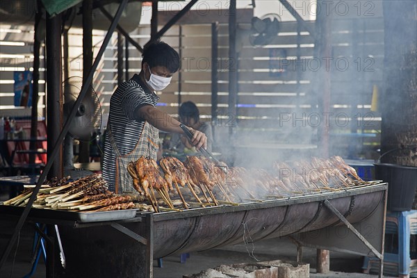 Vendor grilling chicken