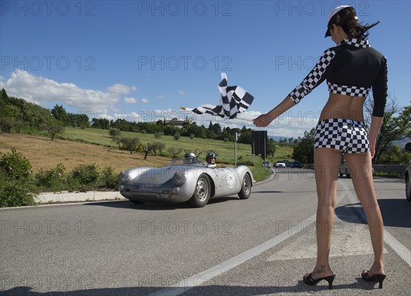 Grid girl holding a chequered flag