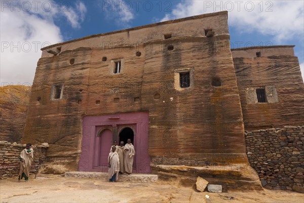 Orthodox monks in front of the rock-hewn church of Mikael Imba