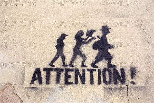 Graffiti on a wall 'Attention!' as a warning against pickpocketing in Lisbon