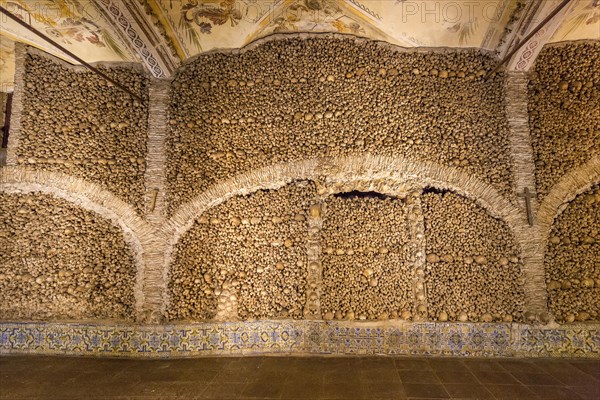 Stacked bones and skulls in the ossuary