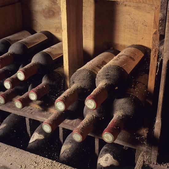 Dusty bottles of Bordeaux wine in a cellar