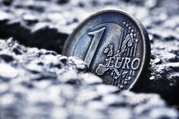 A one euro coin sticking in crevice