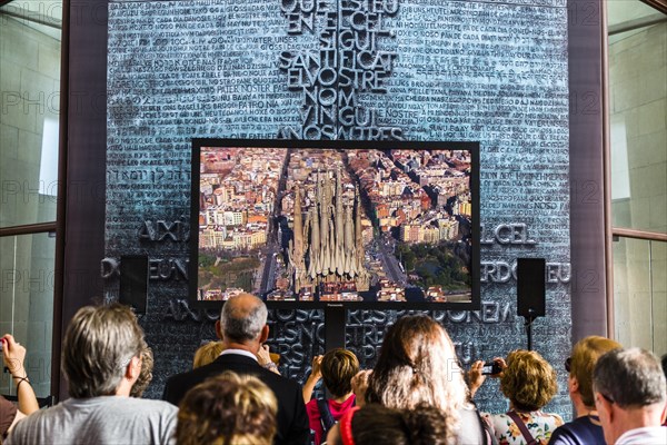 Visitors watching a video of the construction of the Sagrada Familia