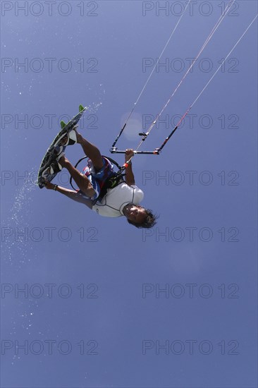 Kitesurfer jumping with splashing water