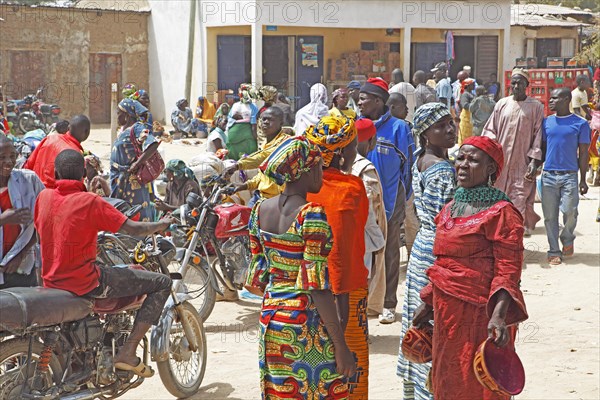 Woman selling typical gourd helmets at a market