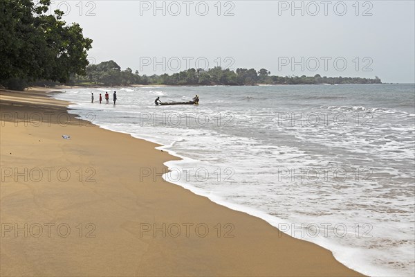 Fishermen with a boat on the beach